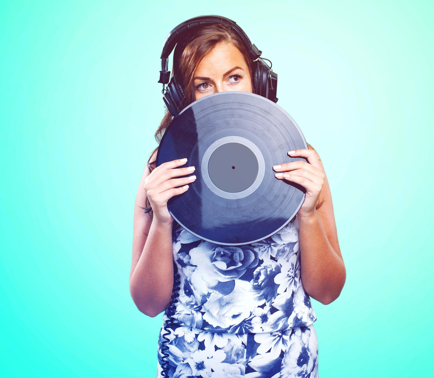 "A woman with headphones holds a vinyl record in front of her face, representing the Voiceover Demo Production – Professional Agency-Ready Demos service, against a vibrant blue background."